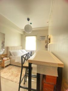 a room with a bed and a table and chairs at Casa Ona in Manila