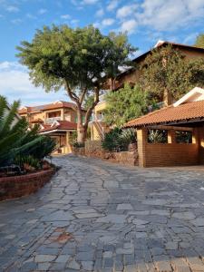 a cobblestone driveway in front of a house at Boschdal Upmarket Guesthouse in Rustenburg