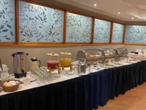 a long table with plates and glasses on it at Hotel CCT Caracas in Caracas