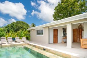 a villa with a swimming pool and a house at Villa Joséphine in Grand-Bourg