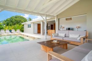a living room with a couch and a table at Villa Joséphine in Grand-Bourg +31 photos