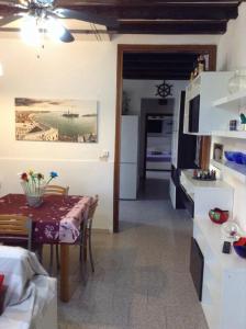 a kitchen and a dining room with a table and a room at Laguna House in Murano