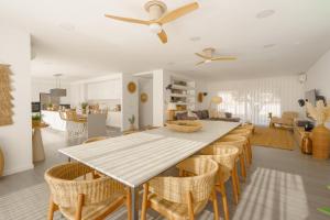 a dining room and living room with a table and chairs at Chill Villa - Signature by Paradise Portugal in Mariquiteira