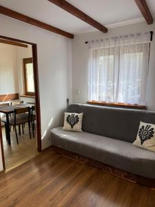 a living room with a couch and a table at Pokoje gościnne Kozica in Zakopane