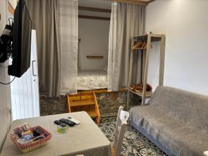 a living room with a couch and a bed at The traditional house-Skalia,kalymnos in Kalymnos