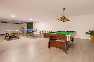 a room with a pool table and ping pong balls at Chill Villa - Signature by Paradise Portugal in Mariquiteira