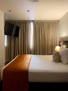 a bedroom with a large bed in front of a window at Hotel CCT Caracas in Caracas +42 photos
