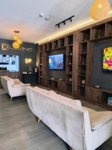 a living room with a couch and a tv at Xliving Host and Rooms in Bogotá