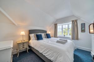 a bedroom with a large bed and a window at Amys Cottage in Sherborne