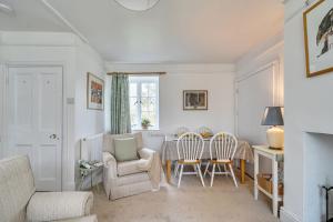 a living room with a couch and chairs and a table at Amys Cottage in Sherborne +31 photos