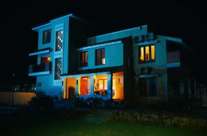 a house with its lights on at night at VILLA De OMR, Private Pool Villa at Old Mahabalipuram Road, Chennai in Kelambākkam