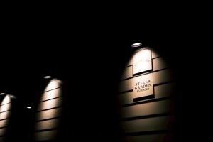 three tall buildings with lights on them in the dark at ララリカ in Kami-furano
