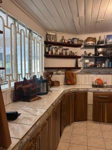 a large kitchen with wooden cabinets and a counter top at Hilltop Candy in San Isidro de El General +5 photos