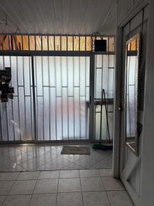 an empty room with glass windows and a door at Hilltop Candy in San Isidro de El General