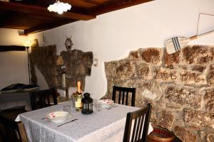 a table in a room with a stone wall at Casa Margherita in Bolsena +35 photos