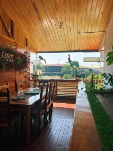 a dining room with a table and wooden ceiling at Hilltop Candy in San Isidro de El General