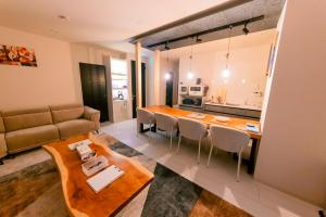 a kitchen and living room with a table and chairs at ララリカ in Kami-furano