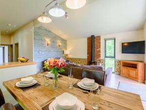 a dining room with a wooden table with flowers on it at 2 Bed in Newark oc-88427 in Walesby