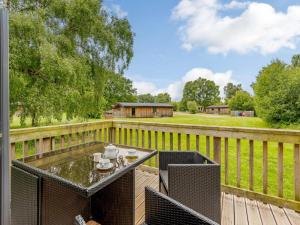 a patio with a table and chairs on a wooden deck at 2 Bed in Newark oc-88427 in Walesby