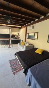a bedroom with a bed and a couch and a table at Florida Private loft, shared garden pool in Florida +36 photos