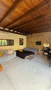 a bedroom with a bed and a couch in a room at Florida Private loft, shared garden pool in Florida