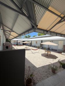 a pavilion with a table and an umbrella at Stella'z guesthouse in Siquijor