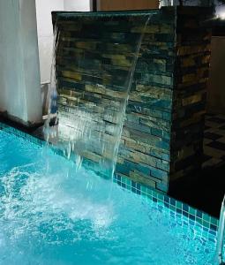 a water fountain in a swimming pool at VILLA De OMR, Private Pool Villa at Old Mahabalipuram Road, Chennai in Kelambākkam