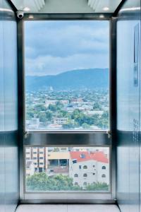 a view of a city through a window at Intercity Tower Hotels in San Pedro Sula