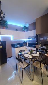 a dining room with a table and chairs in a kitchen at Manila Bay City Lights in Manila
