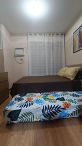 a bedroom with a bed with a colorful blanket at Manila Bay City Lights in Manila +5 photos