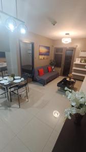 a living room with a couch and a table at Manila Bay City Lights in Manila