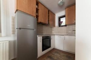 a kitchen with white cabinets and a stainless steel refrigerator at Calm Stay Blidinje in Blidinje +104 photos