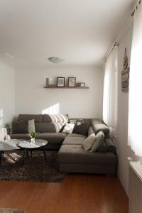 a living room with a couch and a table at Calm Stay Blidinje in Blidinje