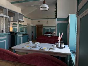 a kitchen with a table with dishes on it at Hotel Villa Fröhlich in Baabe
