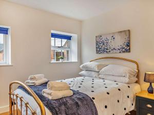 a bedroom with a bed and two windows at 3 Bed in Ashbourne oc-94309 in Windley