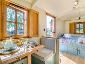a room with a table and a bed and windows at 1 Bed in Leominster oc-93060 in Pembridge