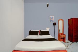 a bedroom with a large bed with a white mattress at Super Hotel Redmoon Residency Elite in Chennai