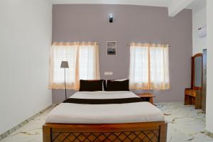 a bedroom with a large bed in a room at Super Hotel Redmoon Residency Elite in Chennai