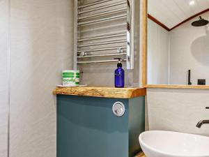 a bathroom with a sink and a blue cabinet at 1 Bed in Lutterworth oc-93760 in Boughton +30 photos