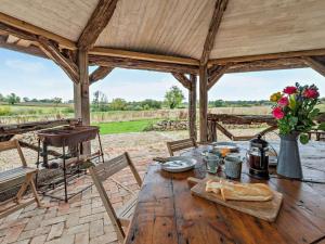 a wooden table in a wooden pavilion with a tableablish at 1 Bed in Lutterworth oc-93760 in Boughton