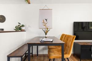 a dining room with a table and two chairs at KOLIBRI - Design Maisonette - Nintendo Switch, Streaming, Bikestore, E-Wallbox in Marburg an der Lahn +9 photos