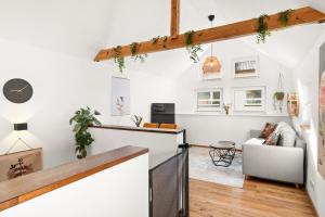 a living room with white walls and wooden beams at KOLIBRI - Design Maisonette - Nintendo Switch, Streaming, Bikestore, E-Wallbox in Marburg an der Lahn