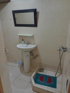 a small bathroom with a sink and a mirror at single bed small room in Casablanca