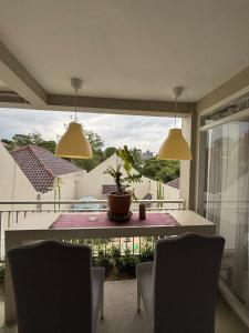 a dining room with a table and chairs and a window at Gyuzel villa di lembang in Citeureup 1
