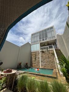 an external view of a building with a swimming pool at Gyuzel villa di lembang in Citeureup 1