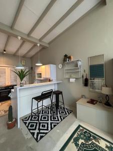 a kitchen with a counter and two chairs in a room at Gyuzel villa di lembang in Citeureup 1