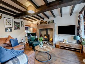 a living room with a couch and a fireplace at 2 Bed in Buxton oc-95993 in Hartington