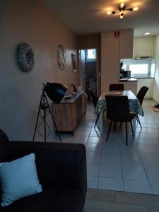 a living room with a table and a dining room at Maison de vacances Etoile de mer 2 in Koksijde