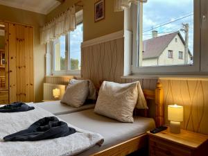 a bedroom with two beds and a window at Penzion Žírovice in Františkovy Lázně