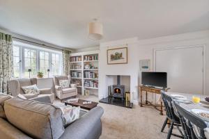 a living room with a couch and a table at South Cottage in Sherborne